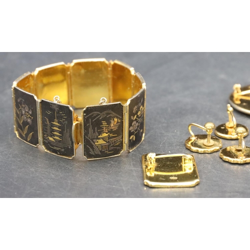 363 - A Japanese Amita panel bracelet on black ground with gilt and silvered landscape and flower decorati... 