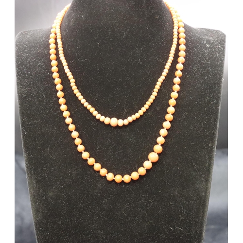 A graduated coral bead necklace and another coral bead necklace with ...