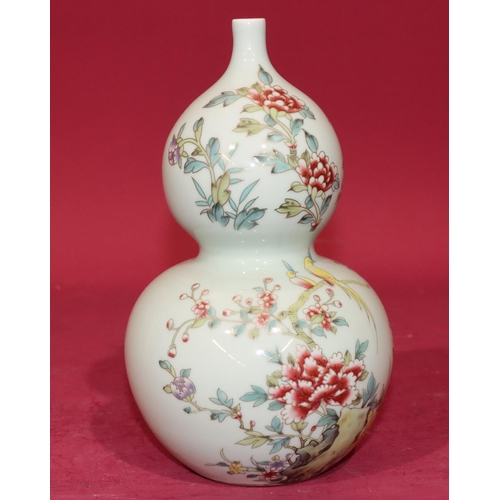 61 - An Oriental gould vase on pale green ground with multi-coloured bird, branch and floral decoration, ... 