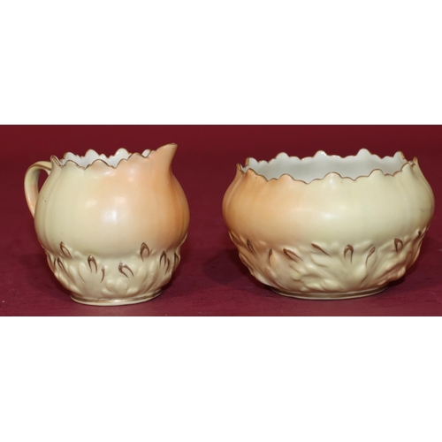 66 - A Locke & Co. Worcester cream jug and sugar bowl on cream ground with raised floral and leaf decorat... 