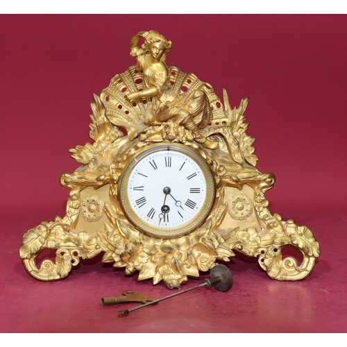 680 - R & C gilt spelter time piece with raised figure motif to top and allover raised floral and leaf dec... 