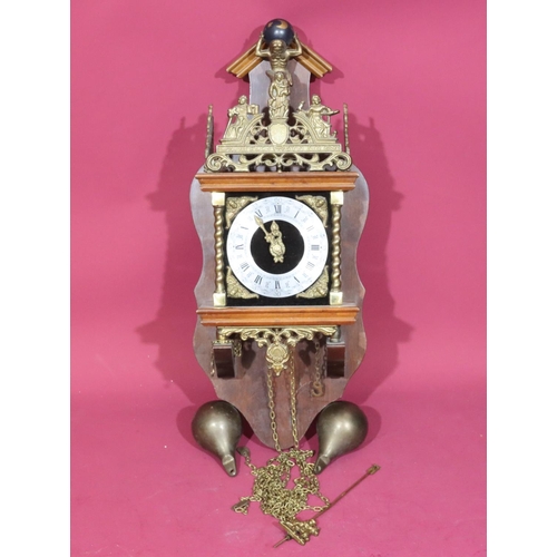 687 - A Continental mahogany and gilt metal hanging wall clock having figure motifs