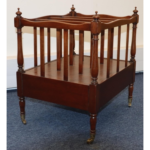 690 - A reproduction mahogany 4-sectioned Canterbury with 1 end drawer and drop handles, on turned legs wi... 