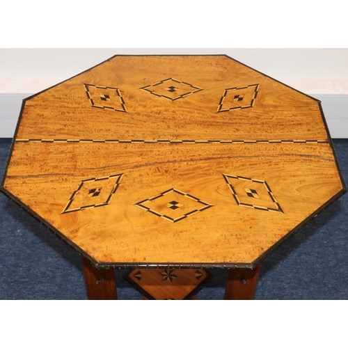 691 - An octagonal low occasional table with inlaid satinwood and ebony boxing and banding, with under tie... 