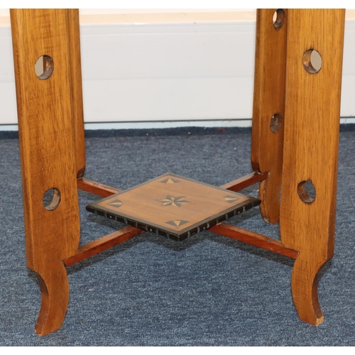 691 - An octagonal low occasional table with inlaid satinwood and ebony boxing and banding, with under tie... 