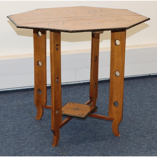 691 - An octagonal low occasional table with inlaid satinwood and ebony boxing and banding, with under tie... 