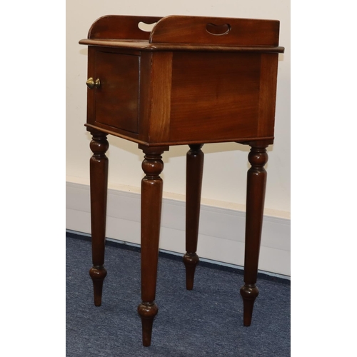 693 - A Victorian mahogany pot cupboard with galleried top, single panel door with knob handle, on round t... 