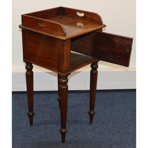 693 - A Victorian mahogany pot cupboard with galleried top, single panel door with knob handle, on round t... 