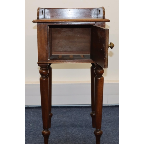 693 - A Victorian mahogany pot cupboard with galleried top, single panel door with knob handle, on round t... 