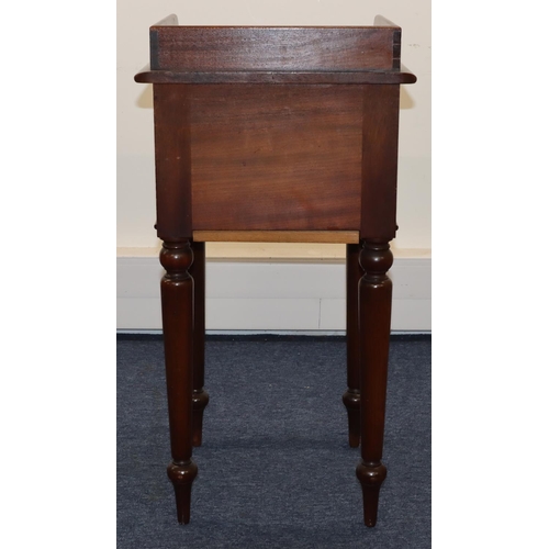 693 - A Victorian mahogany pot cupboard with galleried top, single panel door with knob handle, on round t... 