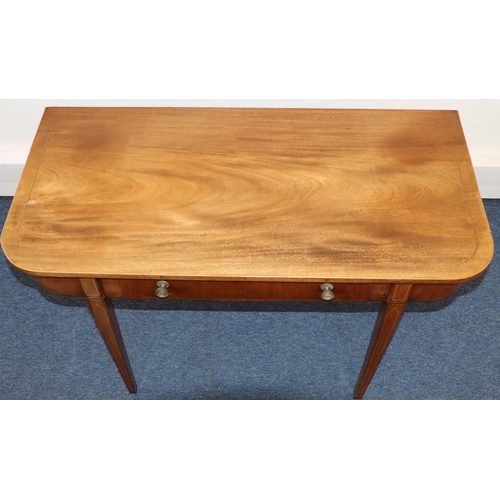 694 - An Edwardian mahogany serving table with inlaid stringing, centre drawer, on 4 square tapering legs,... 