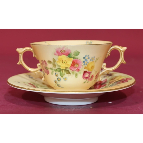 70 - A Royal Worcester Blush 2-handled cup and saucer with multi-coloured floral, leaf and gilt decoratio... 