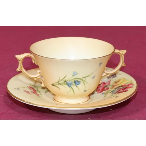 70 - A Royal Worcester Blush 2-handled cup and saucer with multi-coloured floral, leaf and gilt decoratio... 