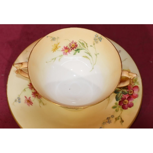 70 - A Royal Worcester Blush 2-handled cup and saucer with multi-coloured floral, leaf and gilt decoratio... 