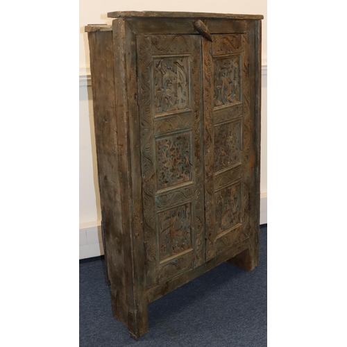 703 - An Eastern carved cabinet with allover raised decoration, on stile feet, 91cm wide, 28.5cm deep, 38c... 