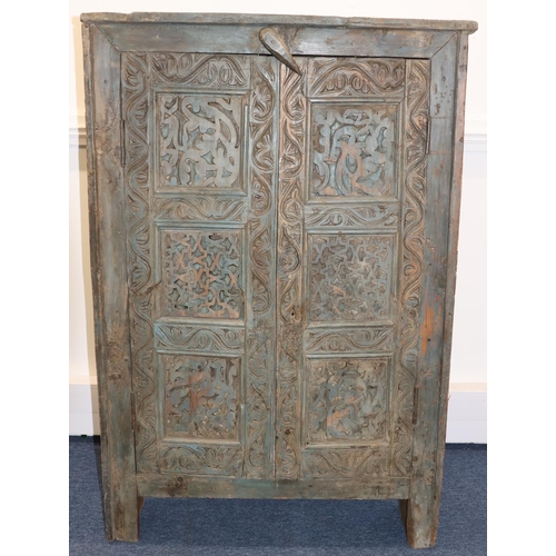 703 - An Eastern carved cabinet with allover raised decoration, on stile feet, 91cm wide, 28.5cm deep, 38c... 