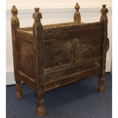 704 - An Eastern food cupboard with allover carved floral, leaf and scroll decoration, 1 sliding door, on ... 