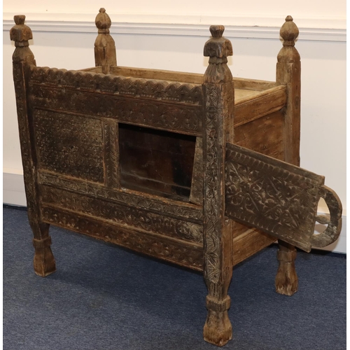 704 - An Eastern food cupboard with allover carved floral, leaf and scroll decoration, 1 sliding door, on ... 