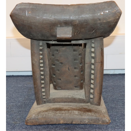 705 - An Ashanti stool with curved top, carved supports, on rectangular base, 56cm wide, 34cm deep, 37cm h... 