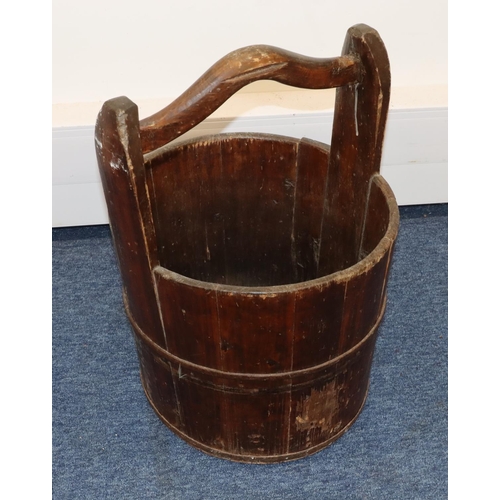 706 - A 19th Century Japanese fruitwood circular bucket with fixed overhead handle and part cast iron band... 