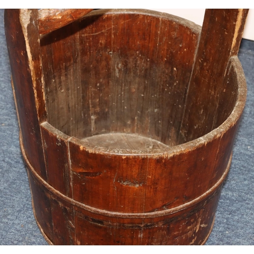 706 - A 19th Century Japanese fruitwood circular bucket with fixed overhead handle and part cast iron band... 