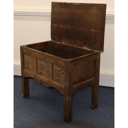 707 - An 18th Century small oak coffer with triple panelled carved front, on stile feet, hinged (inner bot... 