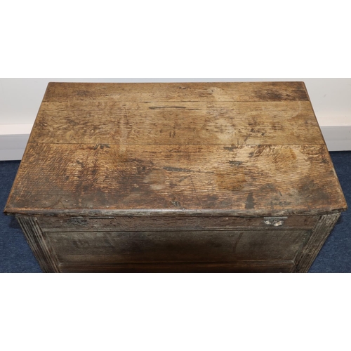 707 - An 18th Century small oak coffer with triple panelled carved front, on stile feet, hinged (inner bot... 