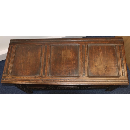 709 - An 18th Century oak coffer with triple panelled front and carved leaf and scroll decoration, triple ... 