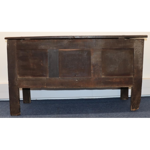 709 - An 18th Century oak coffer with triple panelled front and carved leaf and scroll decoration, triple ... 