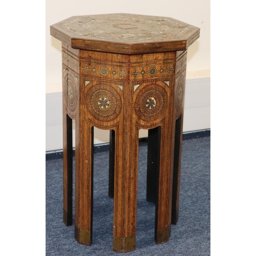 714 - An Eastern octagonal shaped coffee table with allover inlaid brass, Mother of Pearl and boxing decor... 