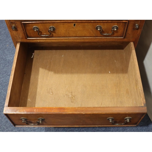 717 - A reproduction mahogany bureau with fall front, 4 long graduated drawers below with drop handles on ... 