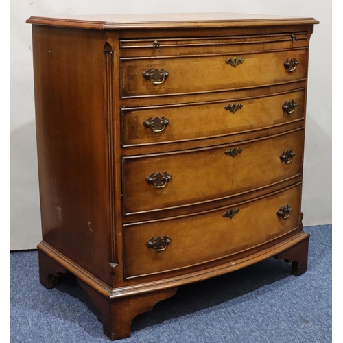 718 - A reproduction walnut small bow fronted chest of drawers with brush slide above 4 long graduated dra... 