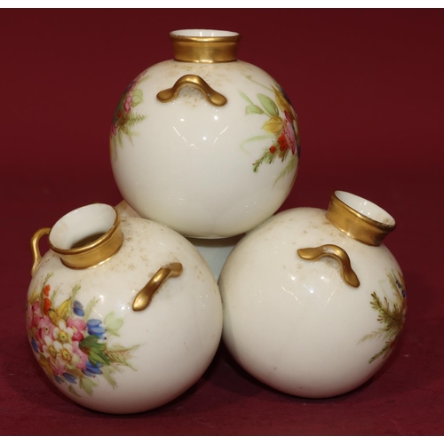 72 - A Royal Worcester vase in the form of 4 balancing bulbous 2-handled vases on white and gilt ground w... 