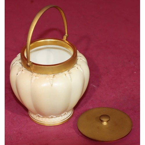 81 - A Royal Worcester Blush round bulbous melon shaped sugar bowl with gilt metal cover and swing overhe... 