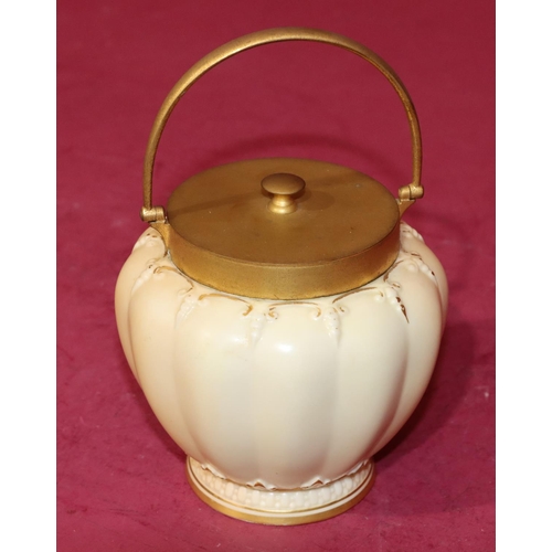 81 - A Royal Worcester Blush round bulbous melon shaped sugar bowl with gilt metal cover and swing overhe... 