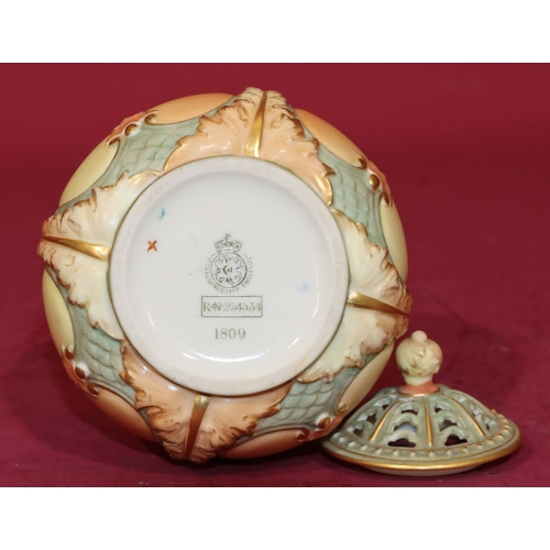 83 - A Royal Worcester Blush round bulbous thin necked lidded pot with multi-coloured thistle, leaf and g... 