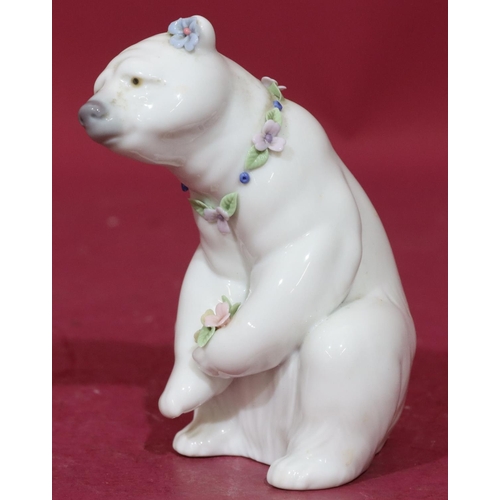 91 - A Lladro figure of a seated polar bear with encrusted floral decoration to neck, 12.5cm high