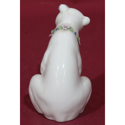 91 - A Lladro figure of a seated polar bear with encrusted floral decoration to neck, 12.5cm high