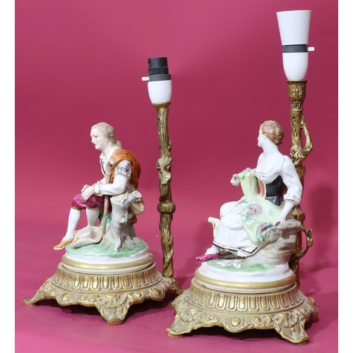 96 - A pair of Continental china and gilt metal table lamps in the form of a seated gentleman and lady, o... 