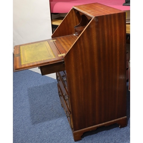 717 - A reproduction mahogany bureau with fall front, 4 long graduated drawers below with drop handles on ... 