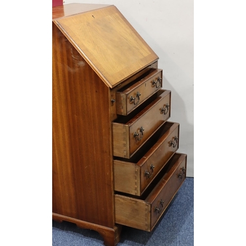 717 - A reproduction mahogany bureau with fall front, 4 long graduated drawers below with drop handles on ... 