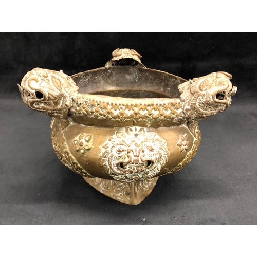 3317 - An Oriental brass pot with 3 insect heads and on triangular base, 21cm wide overall, 15.5cm high