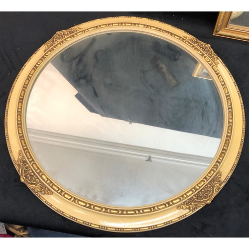 3345 - A large circular mirror in cream and gilt painted frame, 60cm diameter, a smaller circular mirror in... 