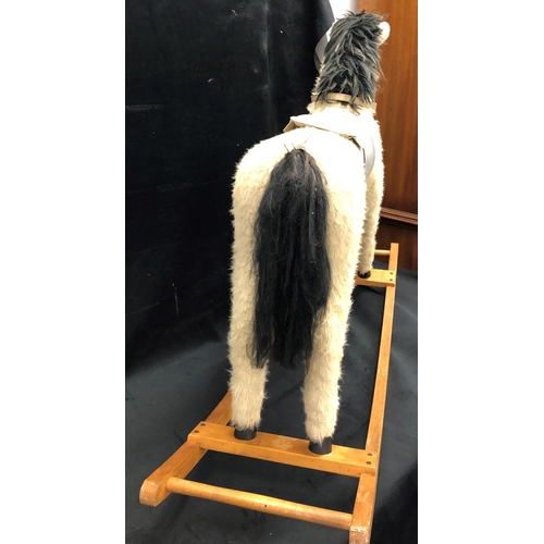 3364 - A vintage rocking horse faux fur, on wood rockers, wood face, 76cm high, 106cm wide.