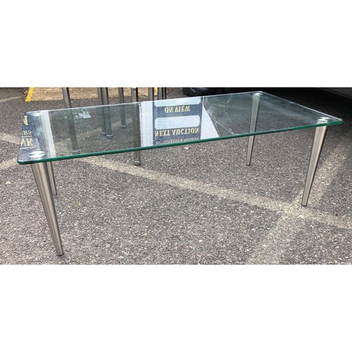 3376 - A rectangular glass topped coffee table on chrome supports, 122cm wide, 61cm deep, 41cm high and a p... 