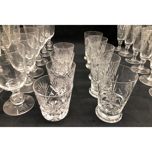 3400 - A set of 10 wine glasses with etched floral and leaf pattern 13cm high, 7 similar etched glasses wit... 