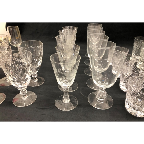 3400 - A set of 10 wine glasses with etched floral and leaf pattern 13cm high, 7 similar etched glasses wit... 