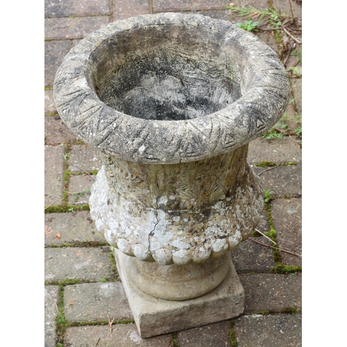 3414 - An urn shaped garden pot on square base with raised leaf and floral decoration, 49.5cm high, 36cm di... 