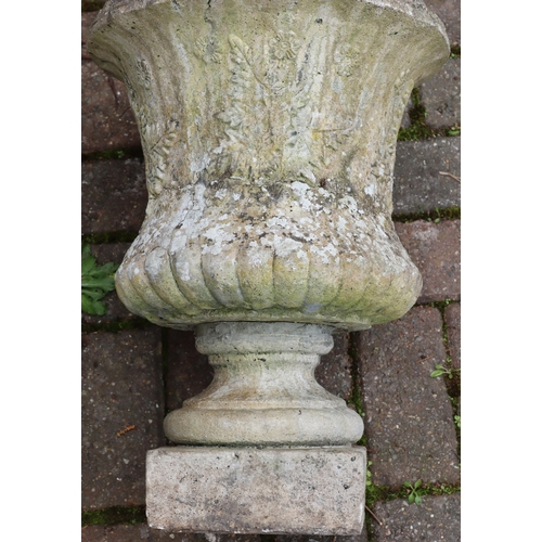 3414 - An urn shaped garden pot on square base with raised leaf and floral decoration, 49.5cm high, 36cm di... 