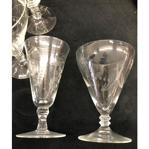 3400 - A set of 10 wine glasses with etched floral and leaf pattern 13cm high, 7 similar etched glasses wit... 